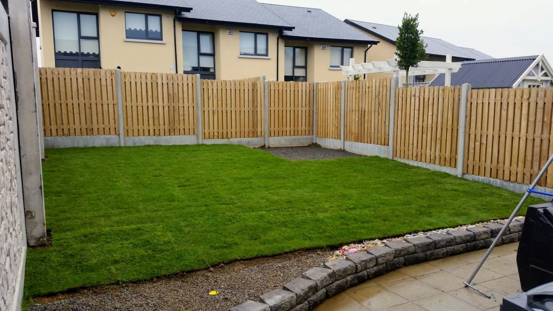 Freshly laid turf lawn with timber fencing in a back garden